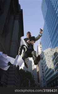 Low angle view of a businessman in mid-air