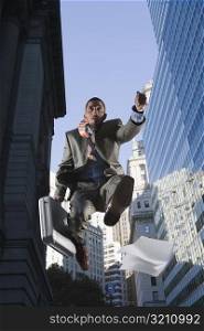 Low angle view of a businessman in mid-air