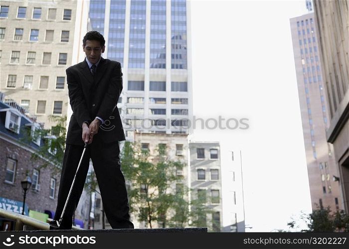 Low angle view of a businessman playing golf