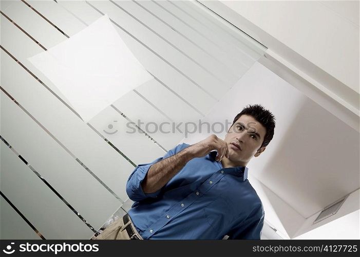 Low angle view of a businessman thinking