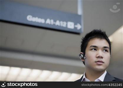 Low angle view of a businessman wearing a hands-free device