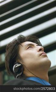 Low angle view of a businessman wearing headphones