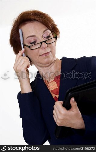 Low angle view of a businesswoman holding a file and a pen