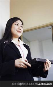 Low angle view of a businesswoman holding an abacus and thinking