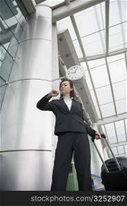 Low angle view of a businesswoman looking at her wristwatch at an airport lounge