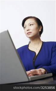 Low angle view of a businesswoman using a laptop