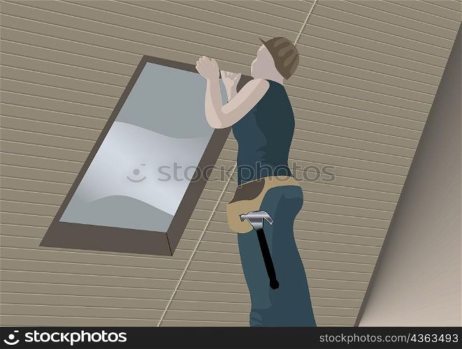 Low angle view of a carpenter repairing a house