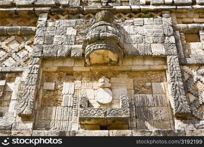 Low angle view of a carved stone wall, Cuadrangulo De los Pajaros, Uxmal, Yucatan, Mexico