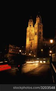 Low angle view of a church lit up at night, Grossmunster Cathedral, Zurich, Switzerland