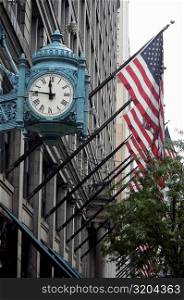 Low angle view of a clock on a building, Marshall Field&acute;s Building, Chicago, Illinois, USA