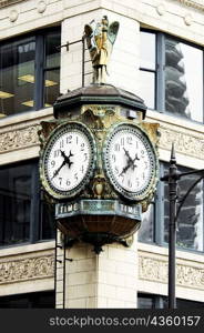 Low angle view of a clock on the side of a building, Chicago, Illinois, USA