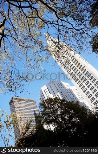 Low angle view of a clock tower near skyscrapers, New York City, New York State, USA