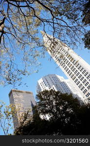 Low angle view of a clock tower near skyscrapers, New York City, New York State, USA