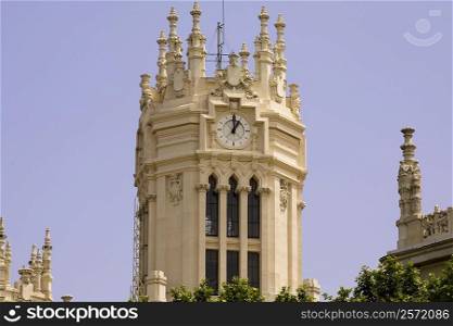 Low angle view of a clock tower, Palacio De Comunicaciones, Plaza de Cibeles, Madrid, Spain