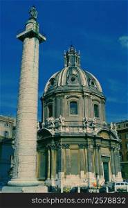 Low angle view of a column in front of a cathedral, Trajan&acute;s Column, Rome, Italy