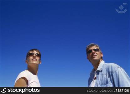 Low angle view of a couple looking upwards