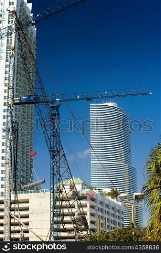 Low angle view of a crane in front of a skyscraper, Miami, Florida, USA