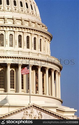 Low angle view of a flag fluttering on a government building, Capitol Building, Washington DC, USA