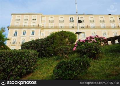 Low angle view of a formal garden in front of a building, Biarritz, Basque Country, Pyrenees-Atlantiques, Aquitaine, France