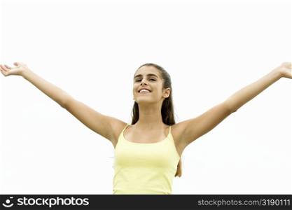 Low angle view of a girl standing with her arms outstretched