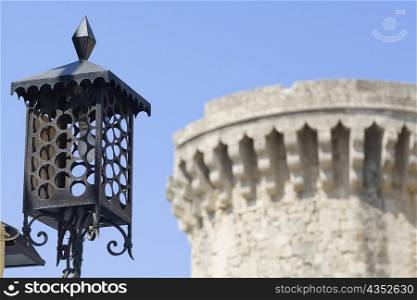 Low angle view of a lamp with a tower in the background, Rhodes, Dodecanese Islands, Greece