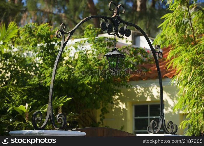Low angle view of a lantern at the entrance of a house