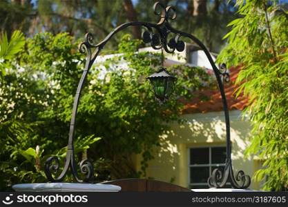 Low angle view of a lantern at the entrance of a house