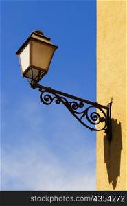 Low angle view of a lantern mounted on the wall, Le Mans, Sarthe, Pays-de-la-Loire, France