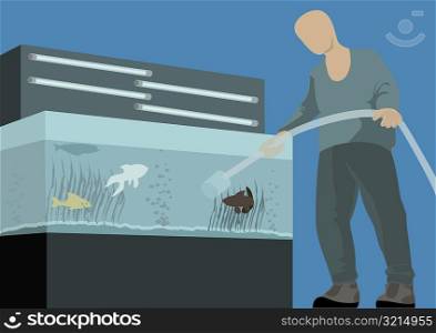 Low angle view of a man filling a fish tank