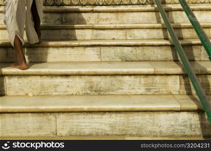 Low angle view of a man walking up stairs, Pushkar, Rajasthan, India