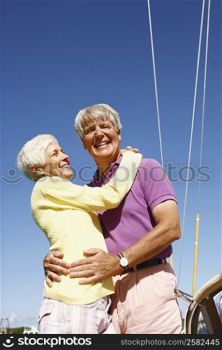 Low angle view of a mature couple embracing each other and smiling