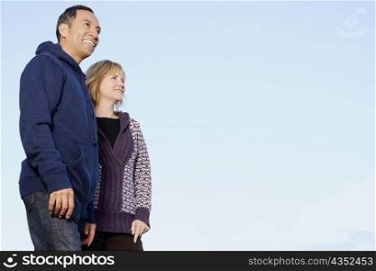 Low angle view of a mature couple standing and smiling