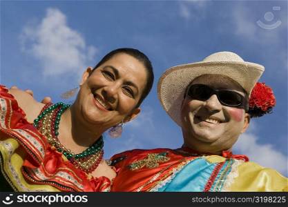 Low angle view of a mature couple wearing costumes and smiling