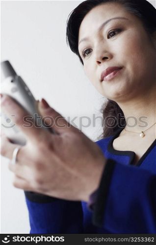 Low angle view of a mature woman operating a mobile phone
