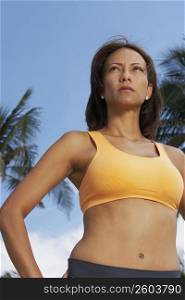 Low angle view of a mature woman standing with arms akimbo