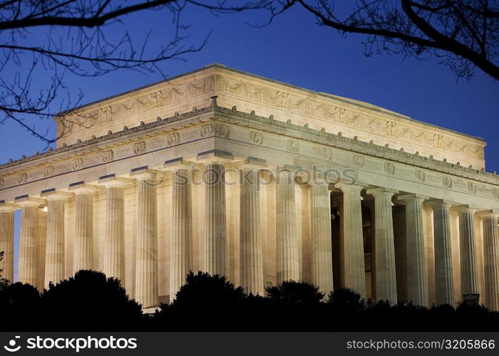 Low angle view of a memorial building lit up at dusk, Lincoln Memorial, Washington DC, USA