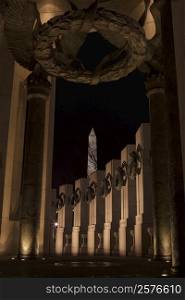 Low angle view of a memorial lit up at night, World War II, Washington DC, USA