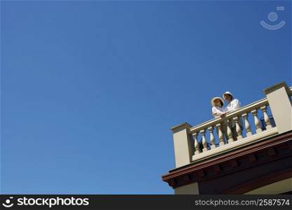 Low angle view of a mid adult couple standing on a terrace