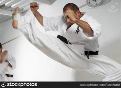 Low angle view of a mid adult man practicing karate