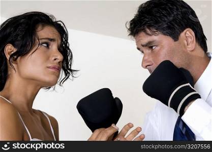 Low angle view of a mid adult man punching a young woman