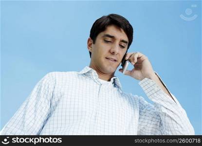 Low angle view of a mid adult man talking on a mobile phone