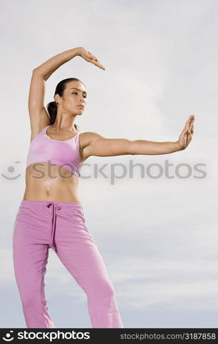 Low angle view of a mid adult woman exercising