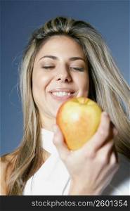 Low angle view of a mid adult woman holding an apple