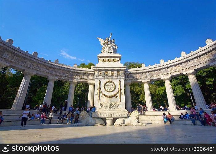 Low angle view of a monument in front of colonnade, Hemiciclo a Benito Juarez, Mexico city, Mexico