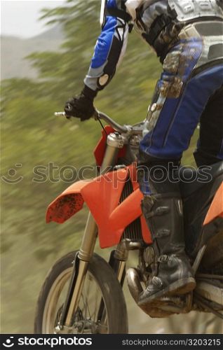 Low angle view of a motocross rider riding a motorcycle