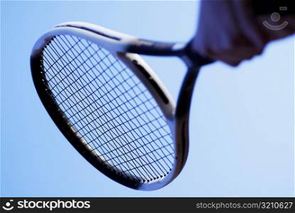 Low angle view of a person&acute;s hand holding a tennis racket