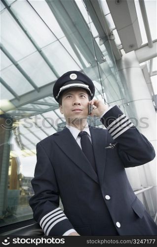 Low angle view of a pilot talking on a mobile phone
