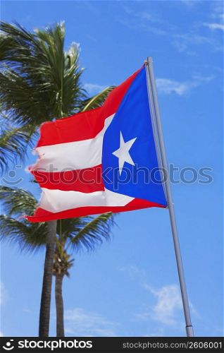 Low angle view of a Puerto Rican flag fluttering, Luquillo Beach, Puerto Rico