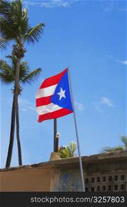 Low angle view of a Puerto Rican flag fluttering, Luquillo Beach, Puerto Rico
