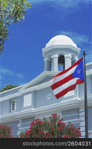 Low angle view of a Puerto Rican flag in front of a building, Old San Juan, San Juan, Puerto Rico